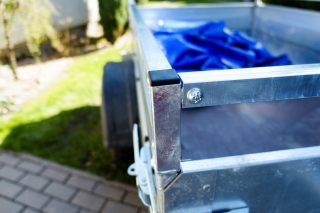 Galvanized trailer in a backyard ready to take rubbish.